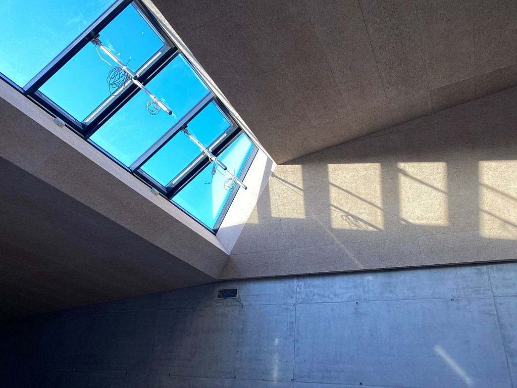 The play of shadows from the many skylights becomes part of the architecture.